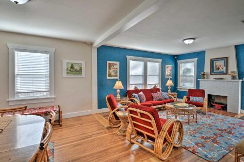 a living room with blue walls and red chairs at Eureka Cottage Near Sequoia Park and Old Town! in Eureka