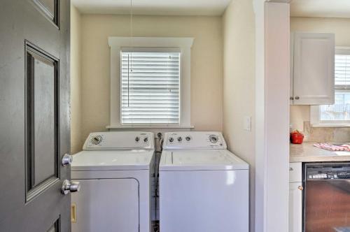 a kitchen with a washing machine and a window at Eureka Cottage Near Sequoia Park and Old Town! in Eureka