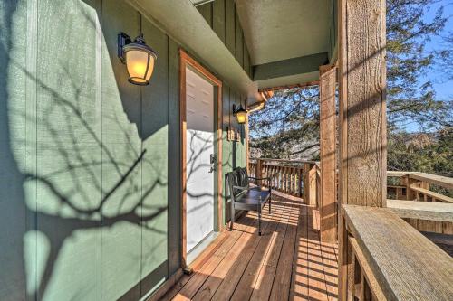 a porch of a house with a bench and a door at Shell Knob Guest House with Lake View, Fire Pit in Shell Knob