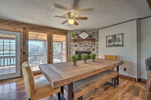 a dining room with a wooden table and a ceiling fan at Lakefront Shell Knob Home with Deck and Gas Grill in Shell Knob
