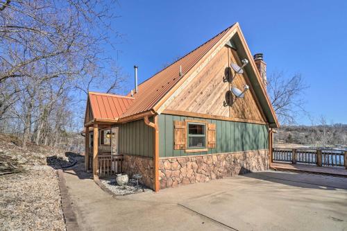 a cabin with a red roof at Lakefront Shell Knob Home with Deck and Gas Grill in Shell Knob