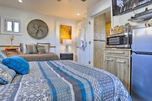 a bedroom with a bed and a living room at Central Elmont Studio with Great Outdoor Space! in Elmont