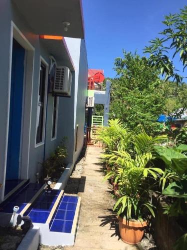 a house with blue solar panels on the side of it at Bayabas,DigFamilyApartment Fully Furnished Near Tandag City in Somosomo