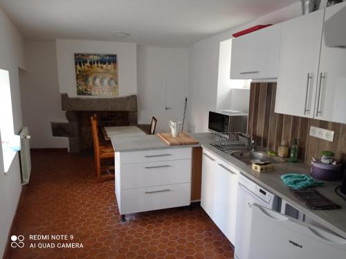 a kitchen with white cabinets and a counter top at Le Terrier du Lapin Blanc in Saint-Brieuc