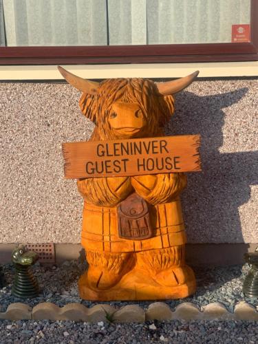 a teddy bear sitting next to a fire hydrant at Gleninver Guest House in Inverness