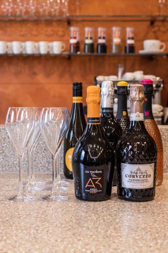 a group of wine bottles and glasses on a counter at Hotel Central Park in Poděbrady