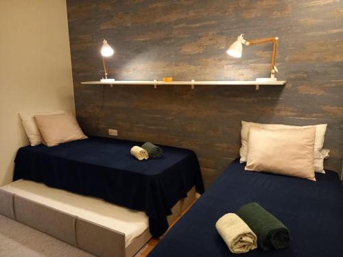 two beds sitting next to each other in a room at Prestige & Nature Apartment in Laguna Village in Quarteira