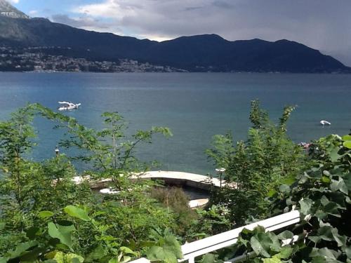 a view of a lake with a boat in the water at Detached Villa with stunning views in Njivice, Montenegro in Njivice