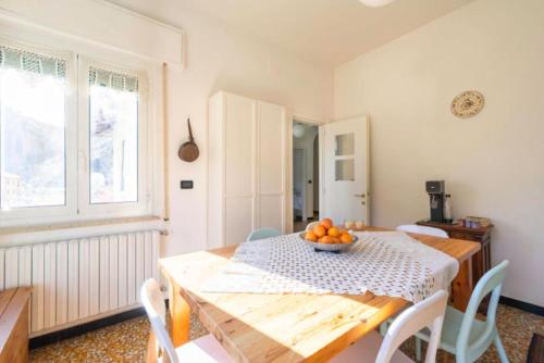 a dining room with a table with a bowl of fruit on it at La casa sul fiume in Albisola Superiore