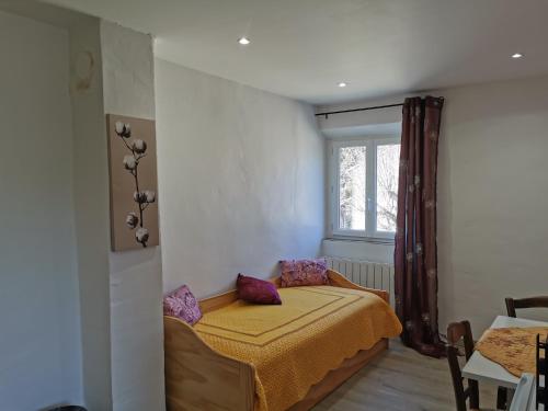 a small bedroom with a bed and a window at 1832 La Rabassière in Malaucène