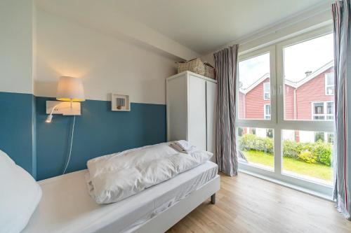 Voodi või voodid majutusasutuse NordseeResort Friesland NordseeResort Friesland 30 toas