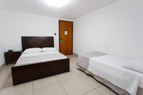 Un ou plusieurs lits dans un hébergement de l'établissement Savassi Hotel