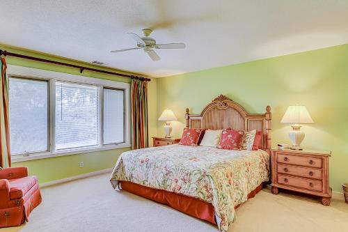 a bedroom with a bed and two windows at Stoney Creek 272 in Hilton Head Island