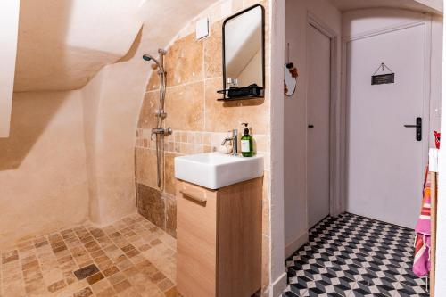 a bathroom with a sink and a shower at La Maison Rose in Grignan