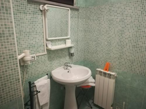 a bathroom with a sink and a mirror at Raggio di Sole in Rende