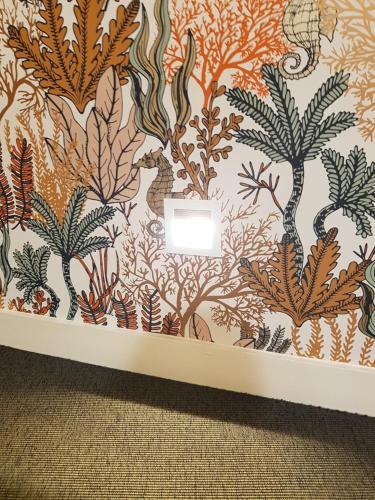 a wall with a colorful mural of seaweeds at Les Chants d'Ailes - Hôtel Face Mer in La Turballe