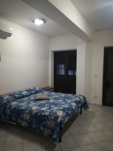a bedroom with a bed with a blue comforter at Raggio di Sole in Rende