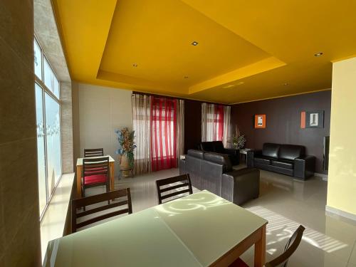a living room with a table and chairs at Hotel Hebe Peniche in Peniche