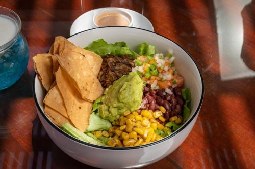 a bowl of food with tortilla chips and a taco salad at Hotel and Dive Center Roatan Yacht Club in Roatán