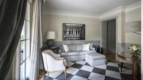 a living room with a couch and a table at Palácio Tangará, Oetker Hotels in Sao Paulo