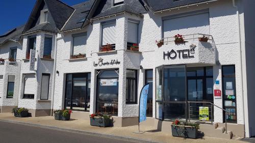 a hotel building on the side of a street at Les Chants d'Ailes - Hôtel Face Mer in La Turballe