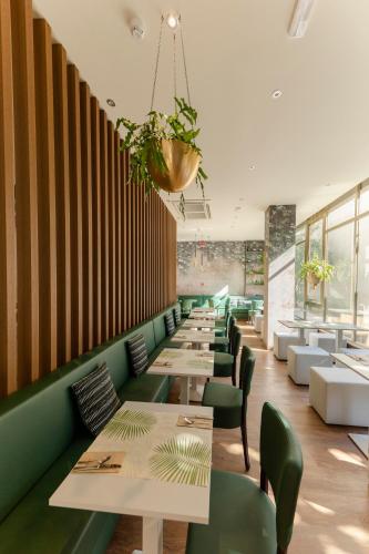 a row of tables and chairs in a restaurant at Bio Boutique Hotel XU' - Gruppo Ambienthotels in Rimini