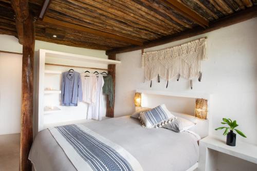 a bedroom with a bed in a room at Amansala Resort in Tulum