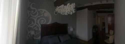 a bedroom with a bed and a chandelier at Il Fonticolo Room & Breakfast in Modena