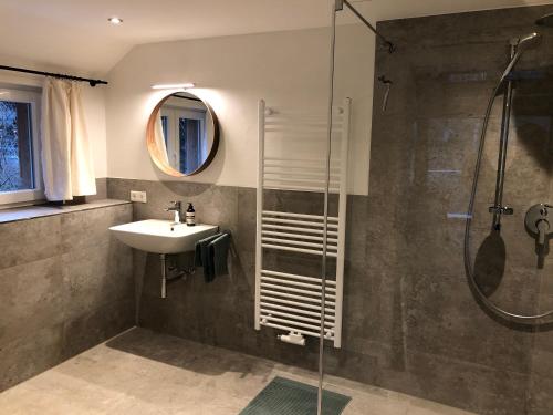 a bathroom with a sink and a shower at Ravenna Lodge in Breitnau