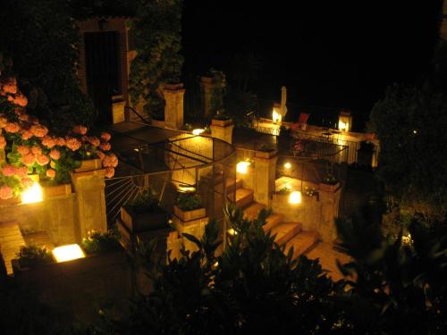 a view of a building with lights at night at La Valle Delle Najadi in Vietri sul Mare
