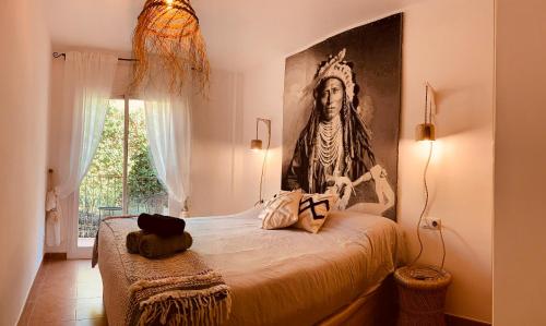 a bedroom with a statue of a man on a bed at Noor apartamento in Begur