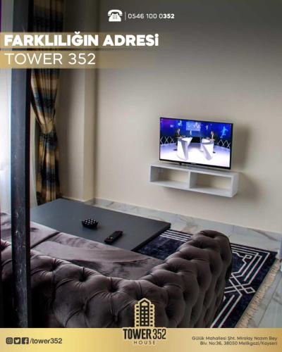 a living room with a couch and a tv at Tower352 in Melikgazi