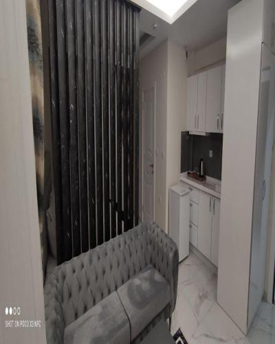a living room with a couch in a kitchen at Tower352 in Melikgazi