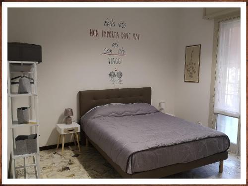 a bedroom with a bed with a sign on the wall at A CASA DI GEMMA in Bologna