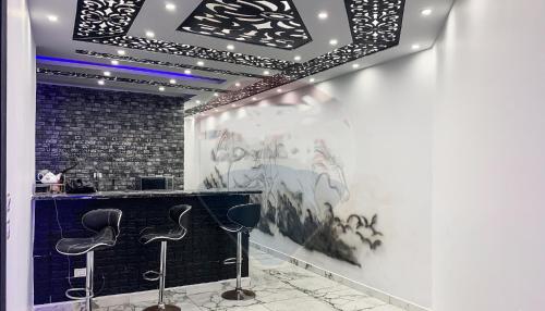 a bar with stools in a room with graffiti at شقة فخمة فيوالبحر Luxury Panorama Sea View in Alexandria