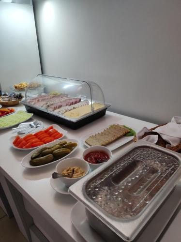 een tafel met verschillende soorten voedsel erop bij Pensjonat Wioletta in Ostrołęka