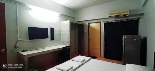 a room with a bedroom with a bed and a mirror at Jirapong apartment in Bangkok