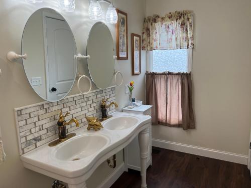 a bathroom with a white sink and a mirror at Holland Farmhouse Inn B&B in Holland