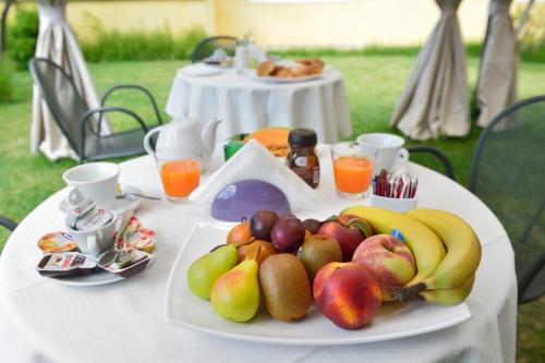 a white table with a plate of fruit on it at Villa Mazzella in Procida