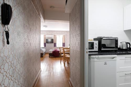 a room with a kitchen and a living room at Central Hoxton Shoreditch in London