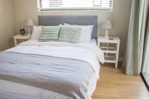 a bedroom with a large bed with two night stands at Avodation in Walvis Bay