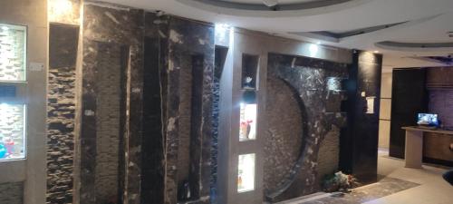 a room with a wall with a bunch of glass at شقة فخمة فيوالبحر Luxury Panorama Sea View in Alexandria