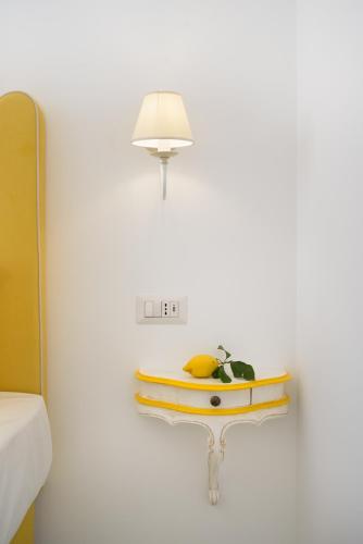 a table with a surfboard on it next to a wall at Casale Guarracino in Sant'Agnello