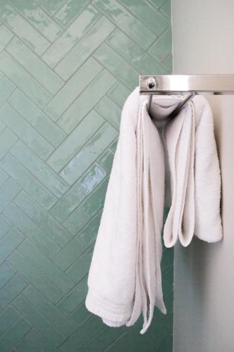 a towel hanging on a towel rack in a bathroom at Avodation in Walvis Bay