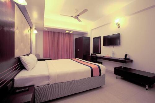 a hotel room with a bed and a television at Cox Beach Resort in Cox's Bazar