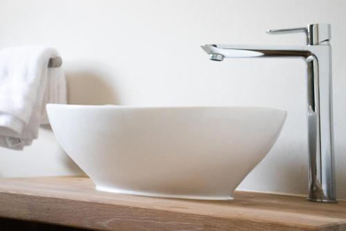 a white bowl sitting on a counter next to a sink at Avodation in Walvis Bay