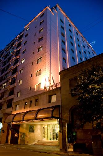 a tall building with lights on the side of it at Argenta Tower Hotel & Suites in Buenos Aires