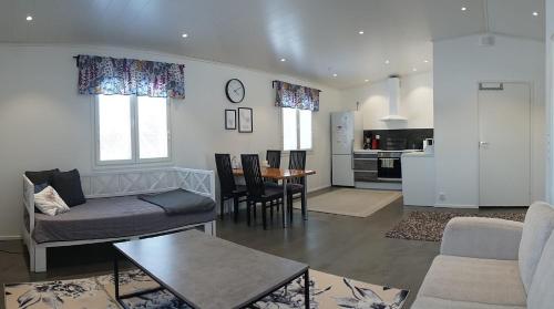 a living room with a couch and a table at Majoitus Valkea in Nunnanen