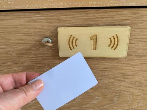 a person holding a piece of paper in front of a lightswitch at Lost Inn Porto Hostel in Porto