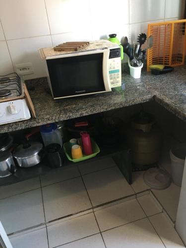 a microwave sitting on top of a kitchen counter at Pousada Astúrias in Ilha Comprida